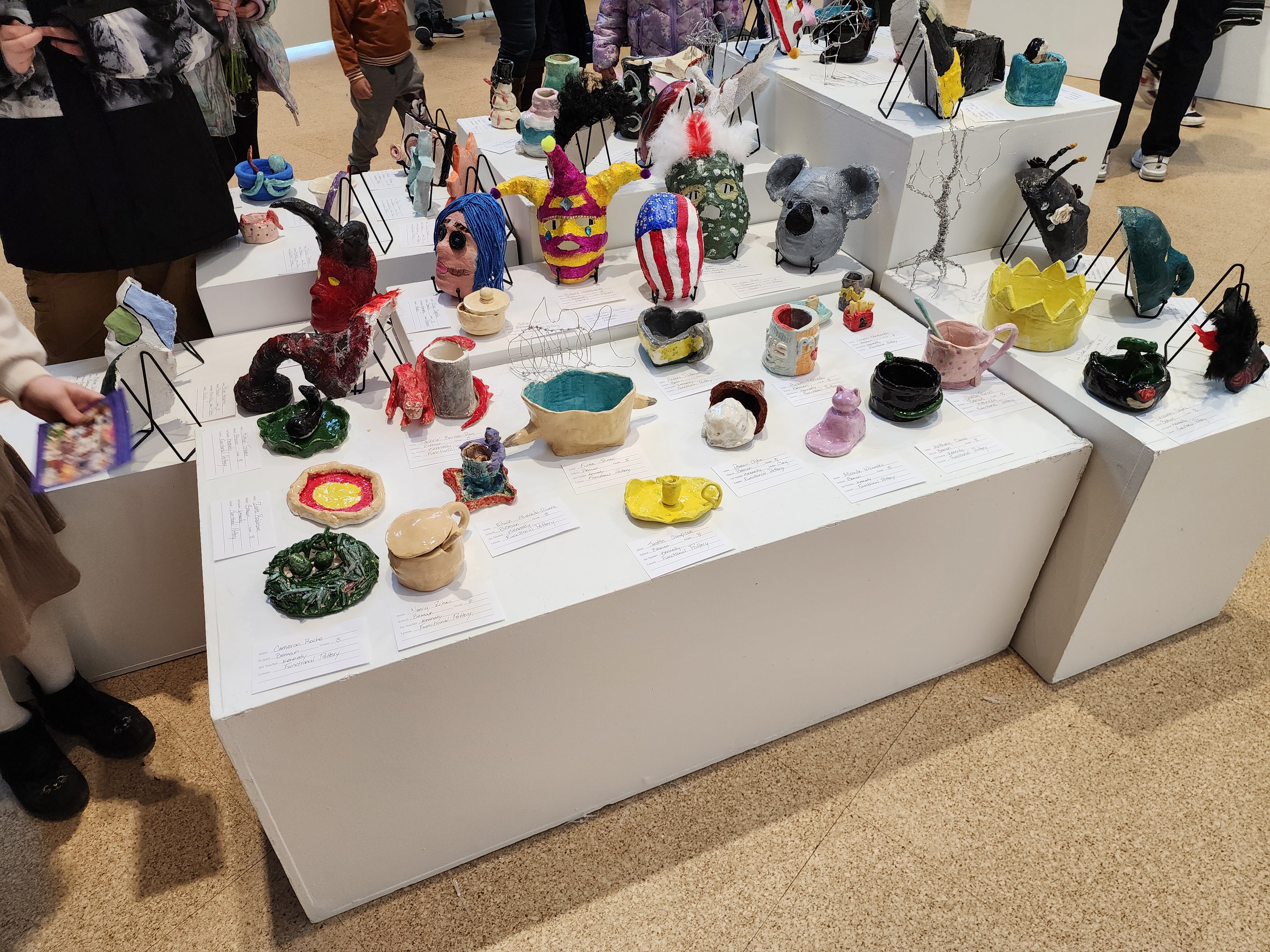 Various pieces of pottery made by Middletown Public Schools students on display in the gallery, ranging in shape, size, color and theme